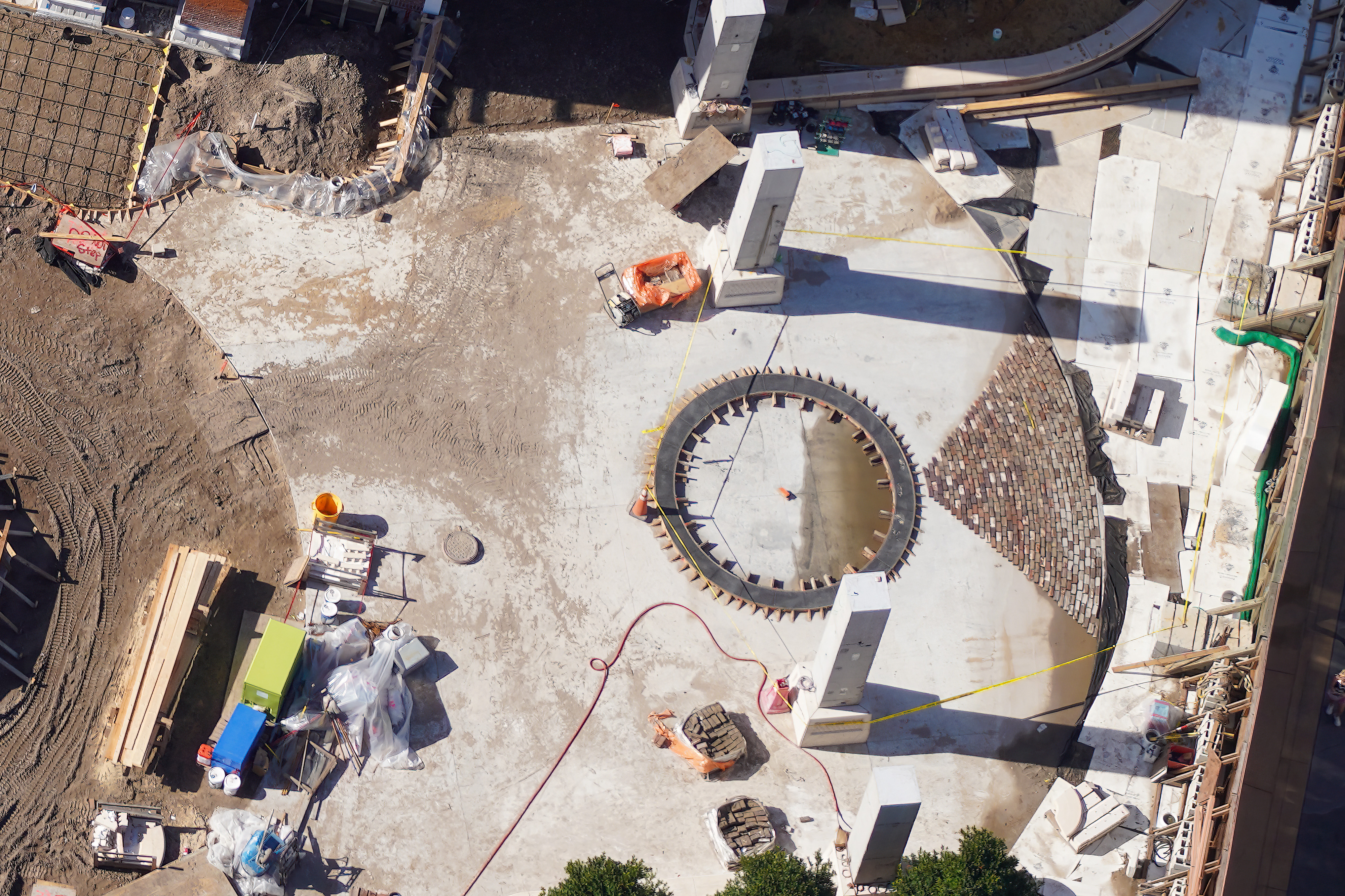 Fan-shaped brick paving under construction at the Monstropolis entrance plaza