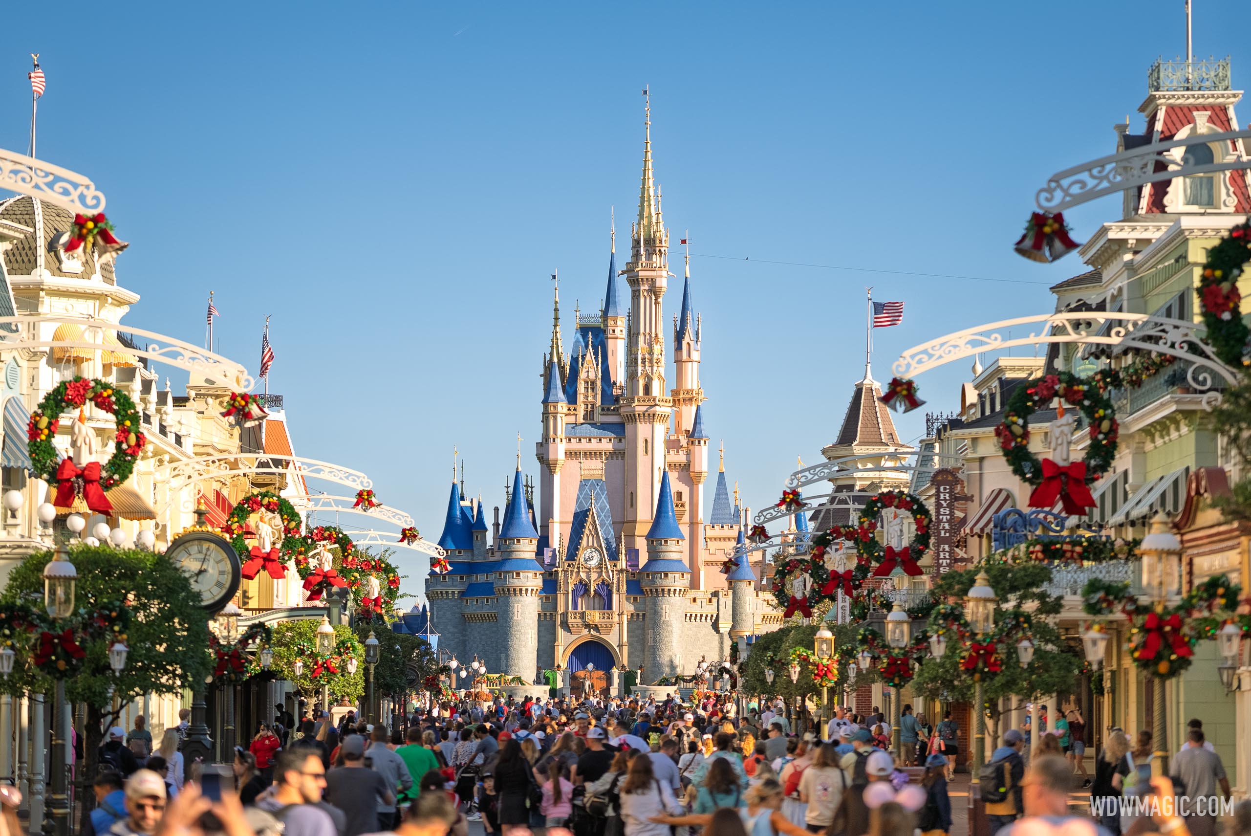 Holiday crowds on a decorated Main Street, U.S.A. facing Cinderella Castle