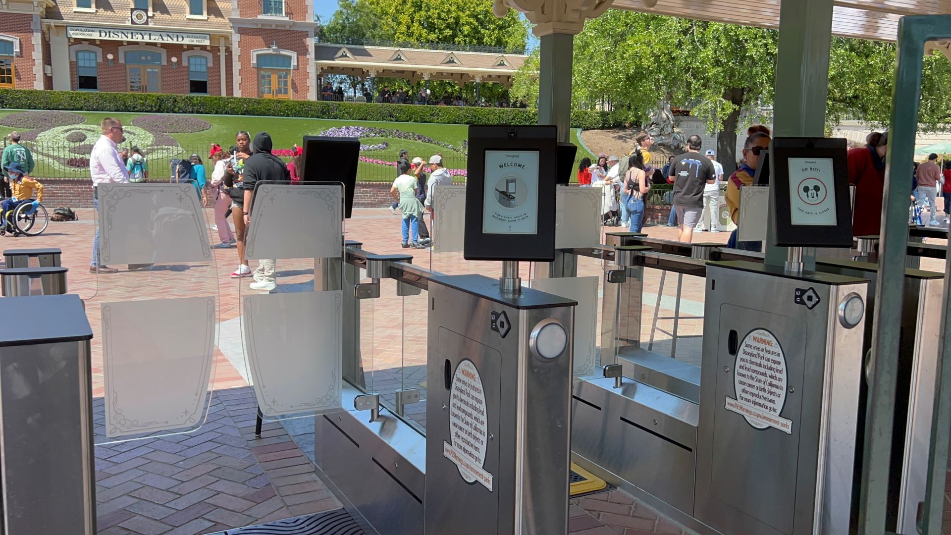 Disneyland’s automated entry gates with welcome screens and Mickey Mouse signage